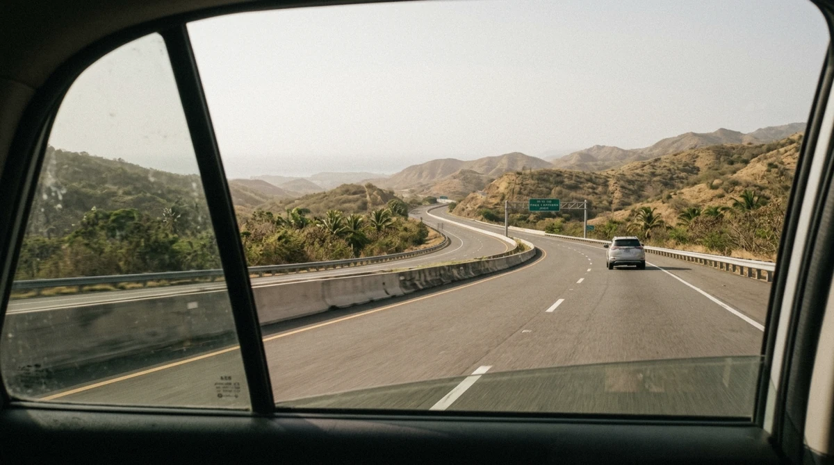 Open toll road running through dry green hills on the south coast of Puerto Rico