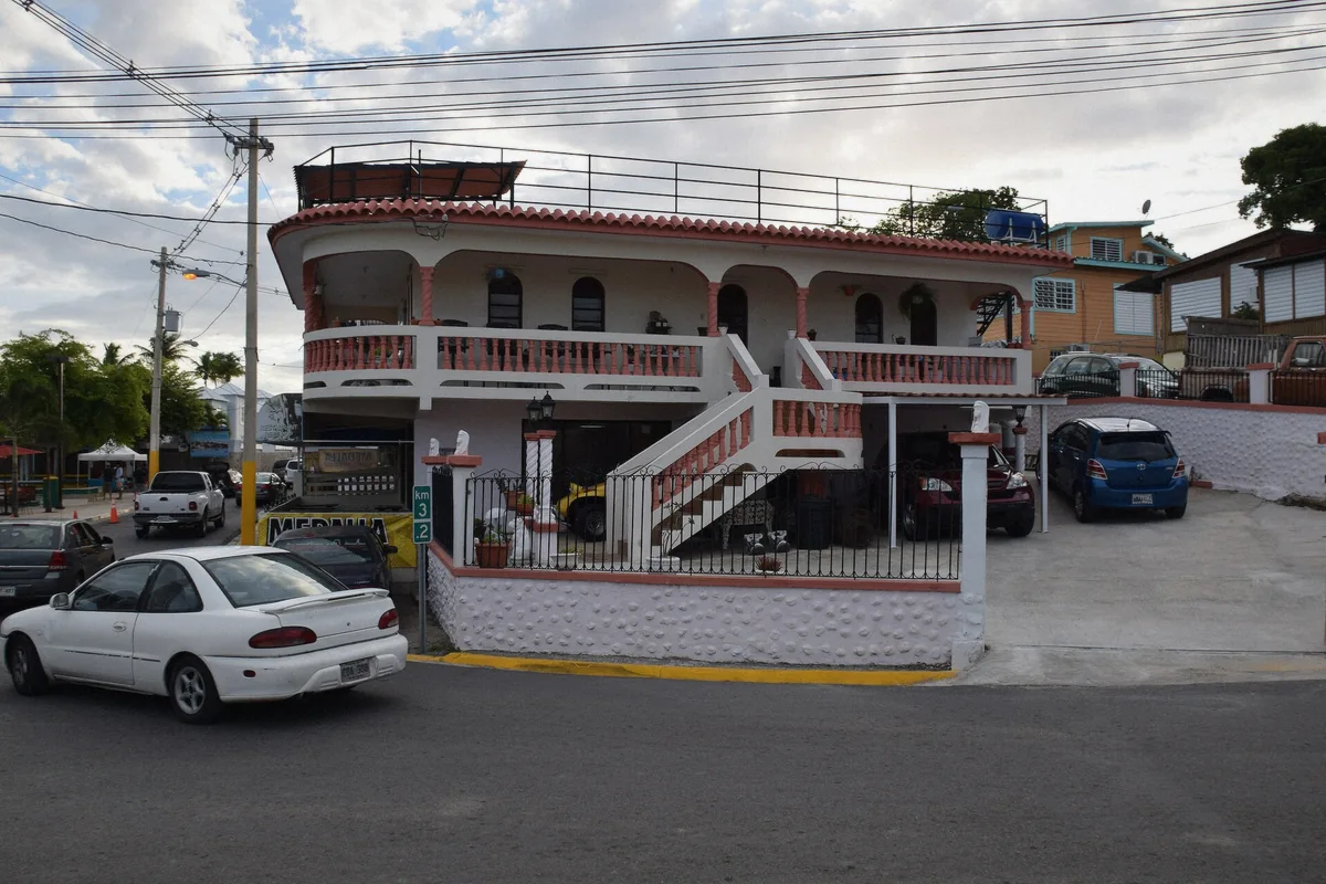 Palm trees beside a small wooden house in the fishing village of Lajas, Puerto Rico